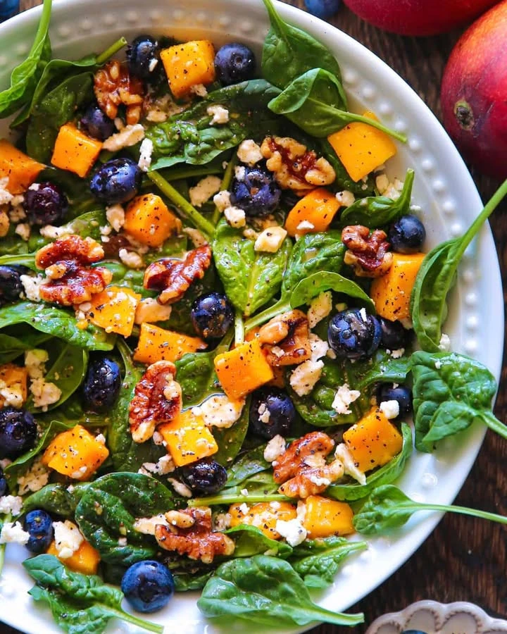 Blueberry Mango Spinach Salad with Walnuts, Feta Cheese, and Lemon Honey Mustard Dressing finished