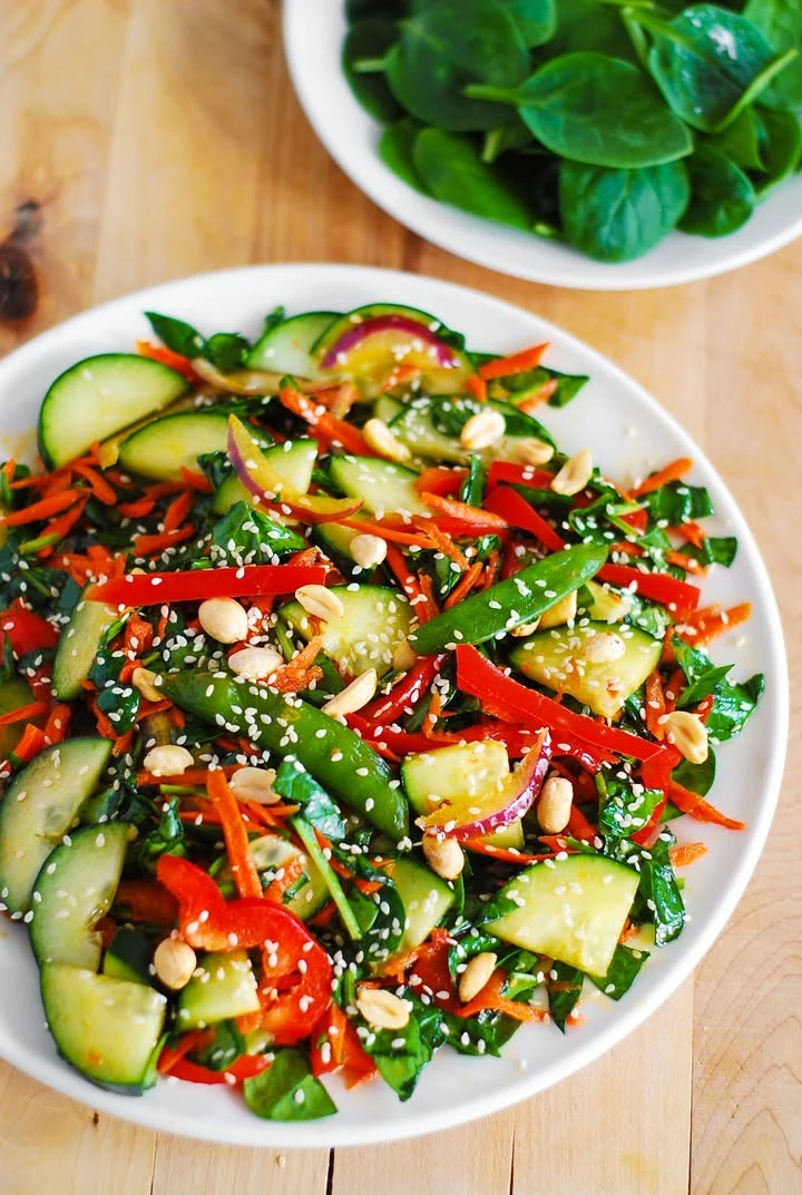 Crunchy Asian salad with Veggies, homemade Peanut Dressing, and Sesame Seeds finished