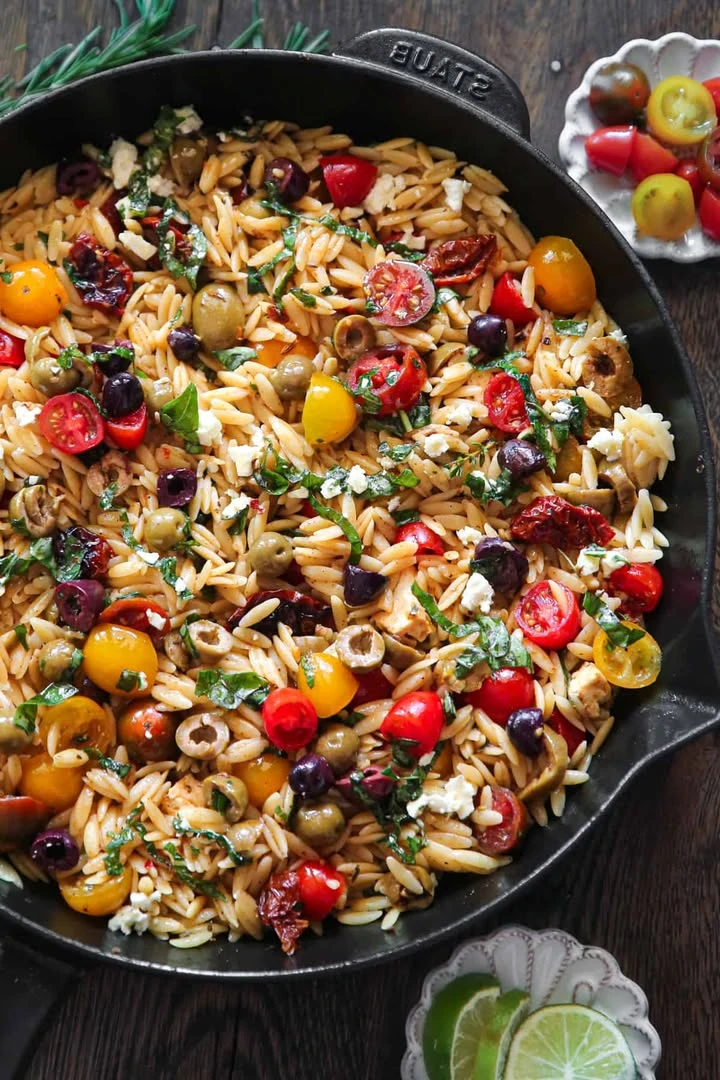 Greek Orzo with Cherry Tomatoes, Sun-Dried Tomatoes, Feta, Green and Kalamata Olives, Lemon Juice, and Fresh Basil finished