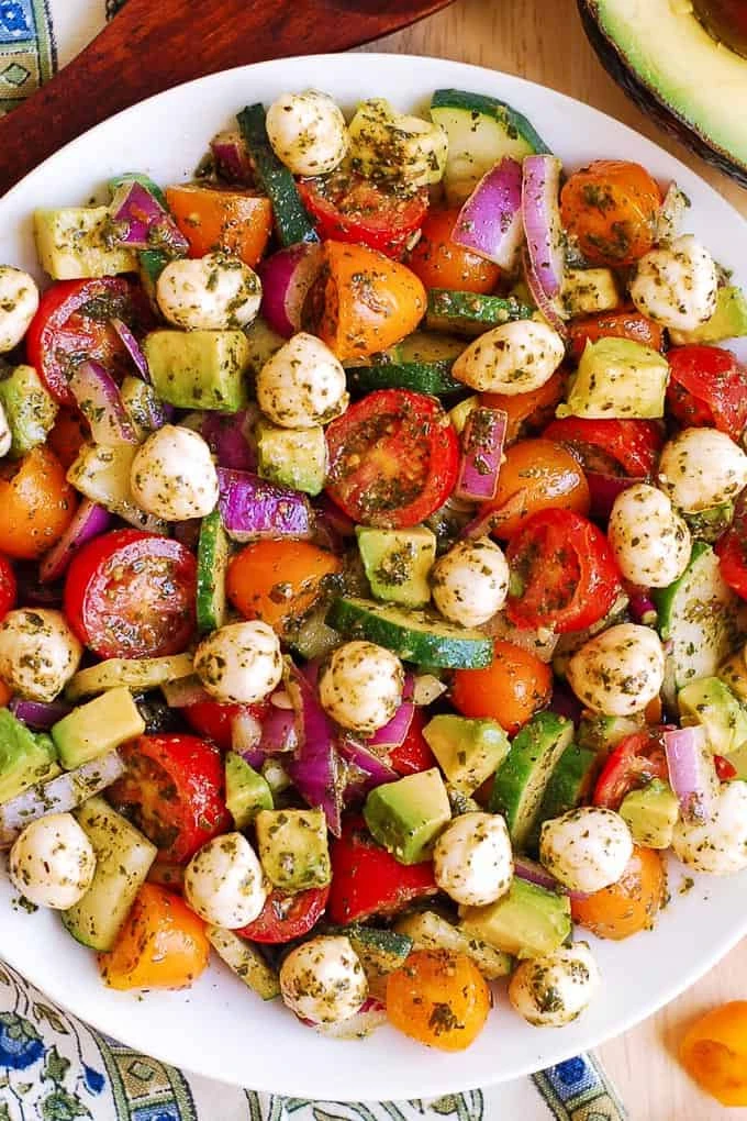 Tomato and Cucumber Salad with Avocado, Mozzarella, and Basil Pesto finished